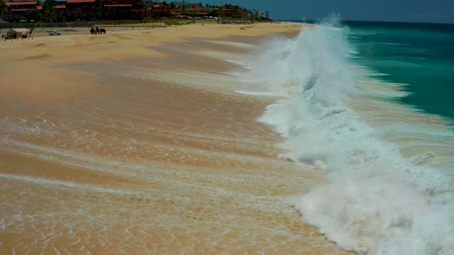 DREAMS LOS CABOS BCS MEXICO-2021: Wave Breaking and Receding on Sandy Beach
