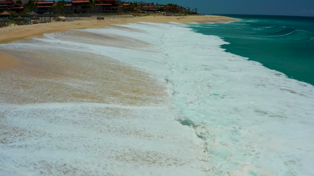 DREAMS LOS CABOS BCS MEXICO-2021: Waves Crashing and Receding on Sandy Shore