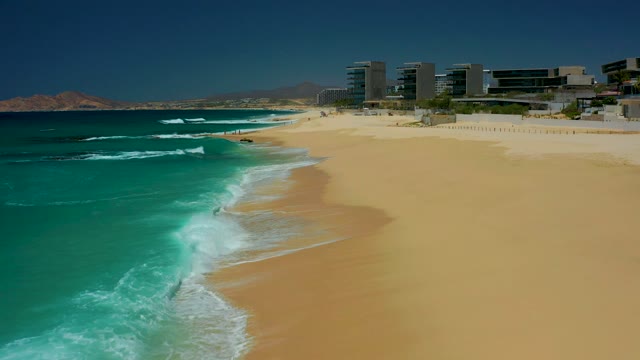 DREAMS LOS CABOS BCS MEXICO-2021: Waves Rolling Onto Sandy Beach Shore