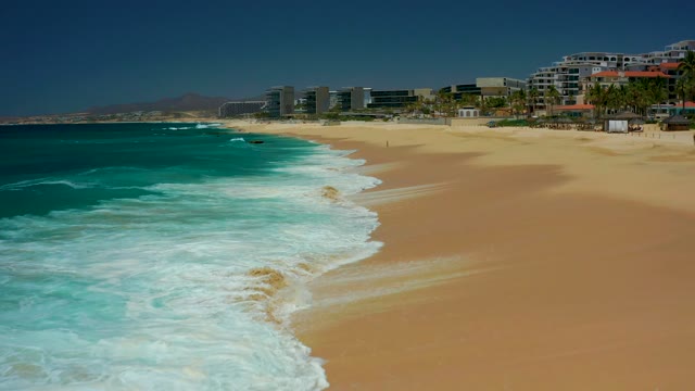 DREAMS LOS CABOS BCS MEXICO-2021: Gentle Ocean Waves Rolling Onto Sandy Shoreline