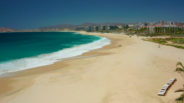 DREAMS LOS CABOS BCS MEXICO-2021: Waves Rolling Onto Sandy Beach Shoreline
