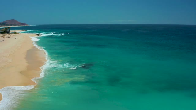 DREAMS LOS CABOS BCS MEXICO-2021: Gentle Waves Lapping a Sandy Shore with Clear Turquoise Water