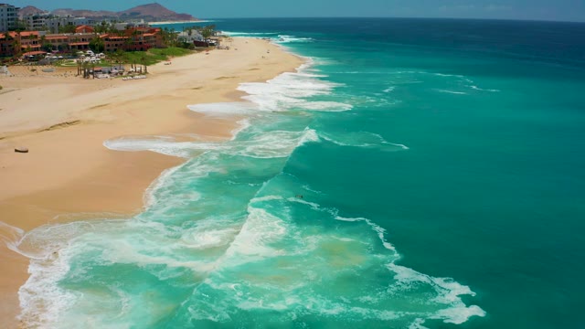 DREAMS LOS CABOS BCS MEXICO-2021: Gentle Ocean Waves Rolling Onto Sandy Shore