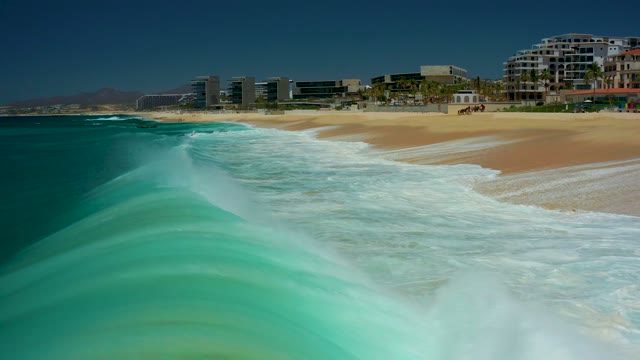 DREAMS LOS CABOS BCS MEXICO-2021: Ocean Waves Rolling Onto Sandy Shore