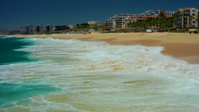 DREAMS LOS CABOS BCS MEXICO-2021: Waves Breaking on Sandy Beach Shoreline