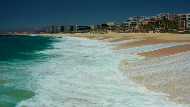 DREAMS LOS CABOS BCS MEXICO-2021: Waves Crashing Onto Sandy Beach Shoreline
