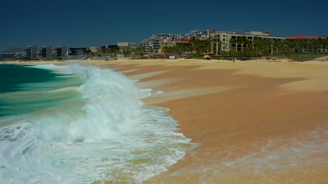 DREAMS LOS CABOS BCS MEXICO-2021: Waves Crashing Onto Sandy Beach Shoreline