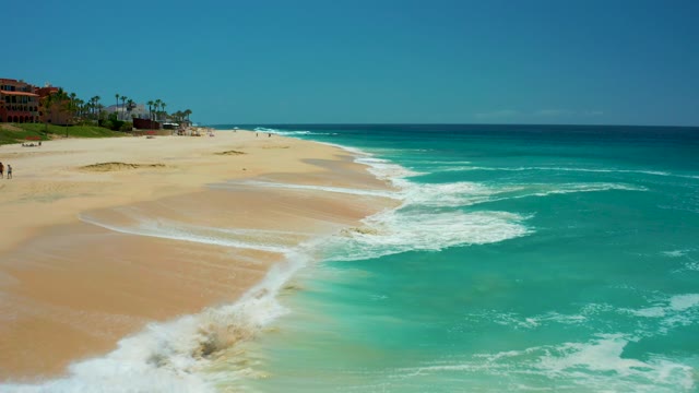 DREAMS LOS CABOS BCS MEXICO-2021: Waves Rolling Onto Sandy Beach From Aerial View