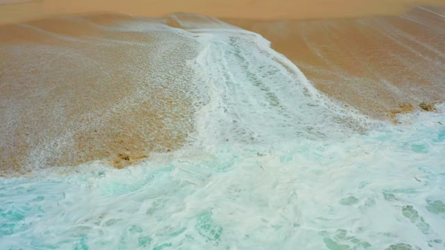 DREAMS LOS CABOS BCS MEXICO-2021: Waves Crashing and Receding on Sandy Shore