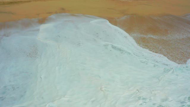 DREAMS LOS CABOS BCS MEXICO-2021: Wave Crashing and Receding on Sandy Shore