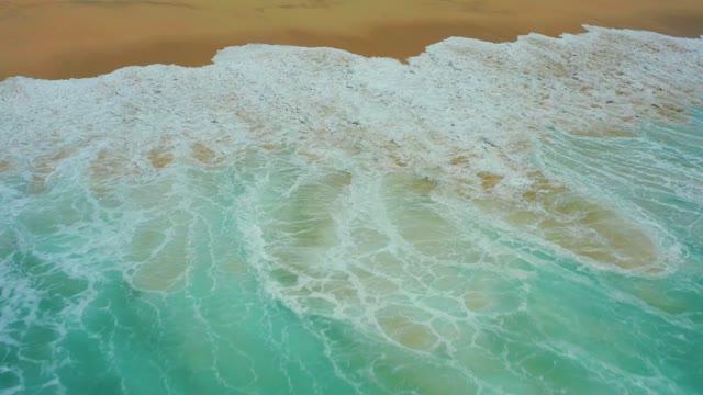 DREAMS LOS CABOS BCS MEXICO-2021: Waves Breaking on Sandy Shore From Aerial View
