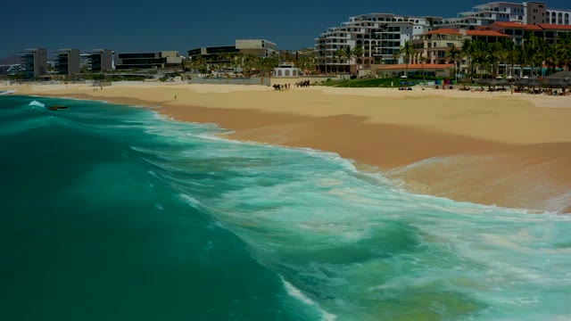 DREAMS LOS CABOS BCS MEXICO-2021: Ocean Wave Approaching and Breaking on Sandy Shore