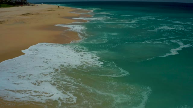 DREAMS LOS CABOS BCS MEXICO-2021: Waves Crashing and Receding on Sandy Shore