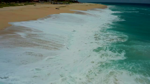 DREAMS LOS CABOS BCS MEXICO-2021: Waves Crashing and Receding on Sandy Shore