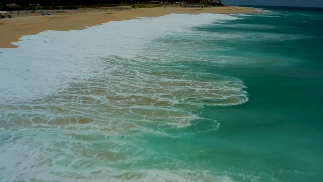 DREAMS LOS CABOS BCS MEXICO-2021: Waves Rolling Onto Sandy Beach with White Foam