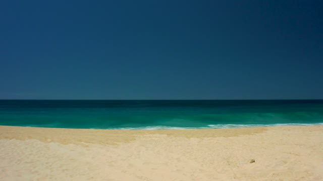 DREAMS LOS CABOS BCS MEXICO-2021: Gentle Ocean Waves Rolling Onto Sandy Shore