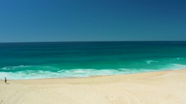 DREAMS LOS CABOS BCS MEXICO-2021: Person Walking on Sandy Beach Then Disappearing