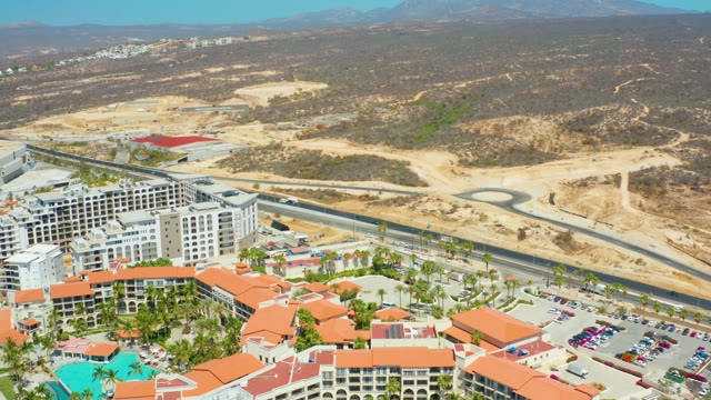 DREAMS LOS CABOS BCS MEXICO-2021: Car Moving Along Road near Resort and Desert Hills