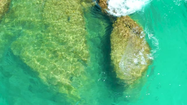 DREAMS LOS CABOS BCS MEXICO-2021: Waves Crashing on Rocky Seabed in Clear Turquoise Water