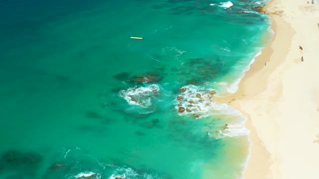 DREAMS LOS CABOS BCS MEXICO-2021: Waves Lapping Rocky Shore on Sandy Beach