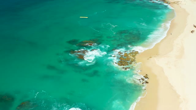 DREAMS LOS CABOS BCS MEXICO-2021: Turquoise Ocean Waves Crashing on Rocky Sandy Beach