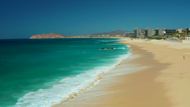 DREAMS LOS CABOS BCS MEXICO-2021: Gentle Ocean Waves Rolling Onto Sandy Shore