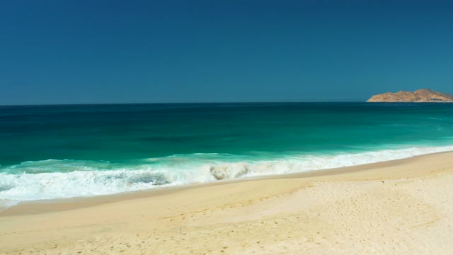 DREAMS LOS CABOS BCS MEXICO-2021: Gentle Ocean Waves Rolling Onto Sandy Beach