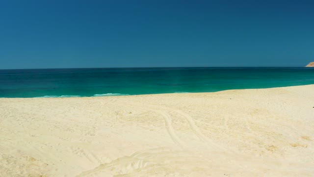 DREAMS LOS CABOS BCS MEXICO-2021: Gentle Waves Rolling Onto Sandy Shore with Distant Headland