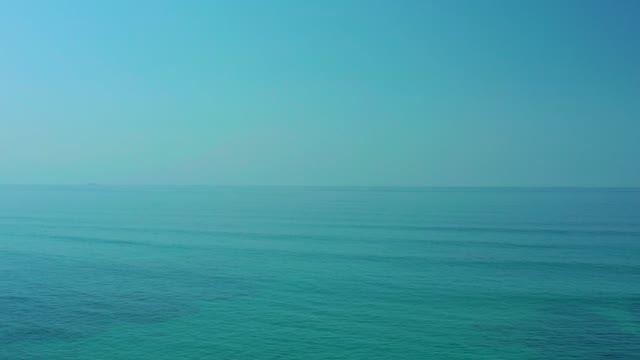 SHIPWRECKS LOS CABOS BCS MEXICO-2021: Calm Ocean with Distant Boat Moving Across Water