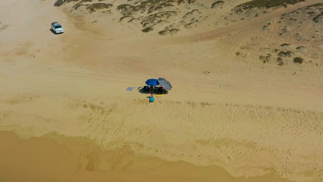 SHIPWRECKS LOS CABOS BCS MEXICO-2021: Person Moving near Blue Umbrella on Sandy Beach