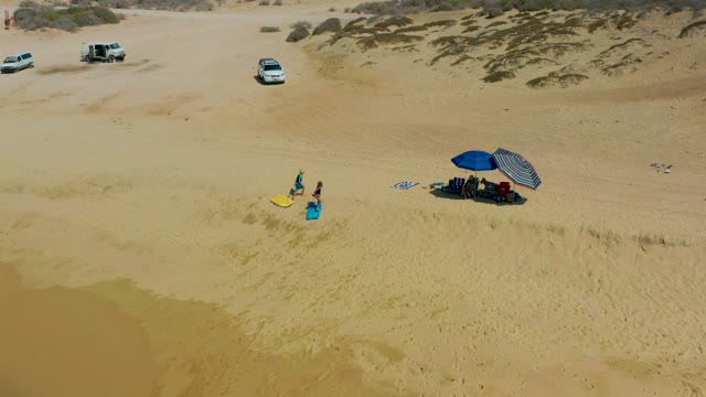 SHIPWRECKS LOS CABOS BCS MEXICO-2021: Two People Carrying Surfboard on Sandy Dunes