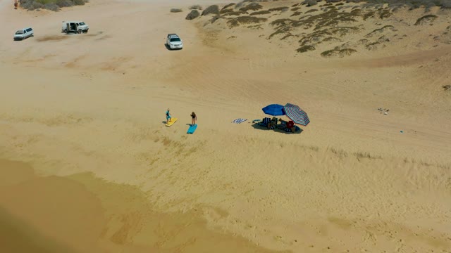 SHIPWRECKS LOS CABOS BCS MEXICO-2021: Beachgoers and Umbrella on Sandy Shore