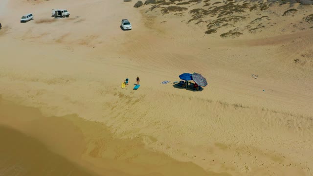 SHIPWRECKS LOS CABOS BCS MEXICO-2021: Beachgoers Moving Near Umbrella on Sandy Shore