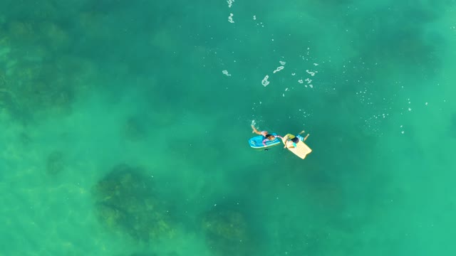 SHIPWRECKS LOS CABOS BCS MEXICO-2021: Two People Paddling on Floating Boards in Clear Water