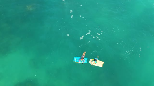 SHIPWRECKS LOS CABOS BCS MEXICO-2021: Two People Floating on Inflatable Boards in Clear Water