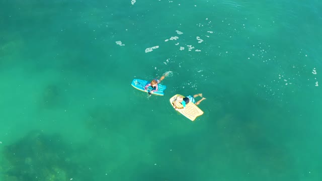 SHIPWRECKS LOS CABOS BCS MEXICO-2021: Two People Floating on Inflatable Boards in Clear Water