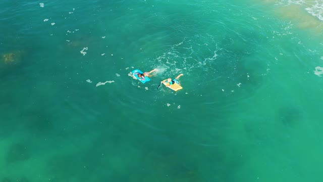 SHIPWRECKS LOS CABOS BCS MEXICO-2021: Person Swimming on a Bodyboard in Clear Ocean Water