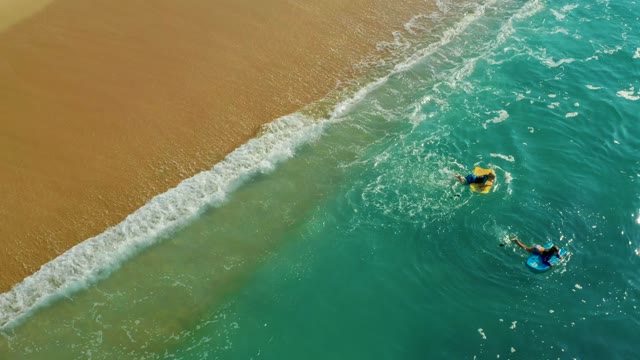 SHIPWRECKS LOS CABOS BCS MEXICO-2021: Two People Bodyboarding in Shallow Ocean Waters
