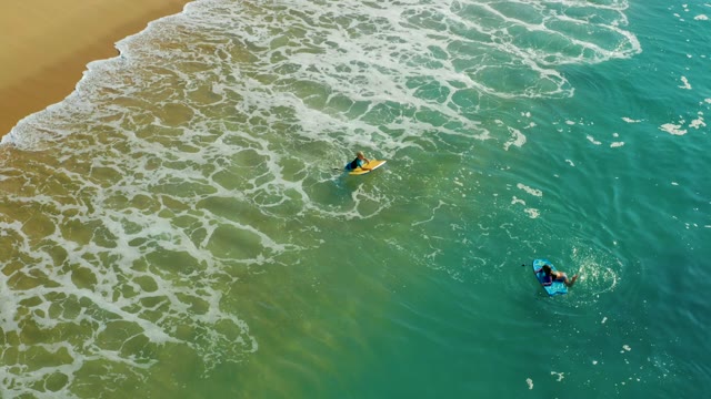 SHIPWRECKS LOS CABOS BCS MEXICO-2021: Two Bodyboarders Paddling in Shallow Ocean Waves