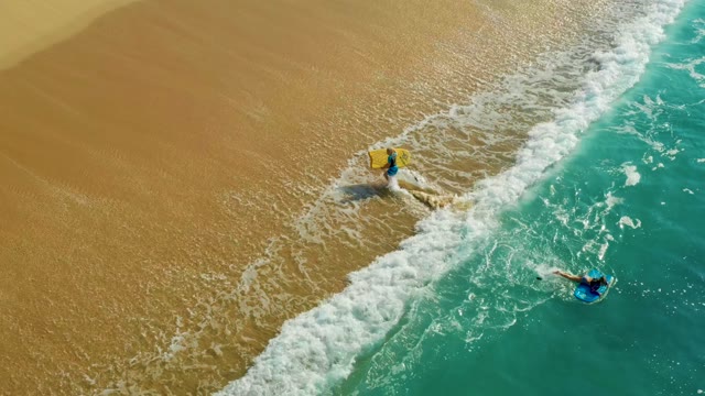 SHIPWRECKS LOS CABOS BCS MEXICO-2021: Bodyboarders Moving in Shallow Ocean Waves