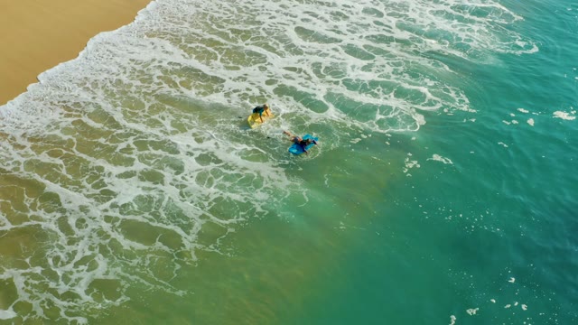 SHIPWRECKS LOS CABOS BCS MEXICO-2021: Two Surfers Paddling in Shallow Ocean Waves