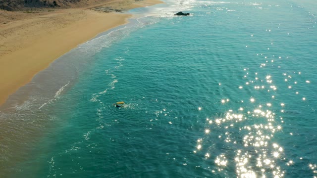 SHIPWRECKS LOS CABOS BCS MEXICO-2021: Surfer Waiting for Wave Near Sandy Shore