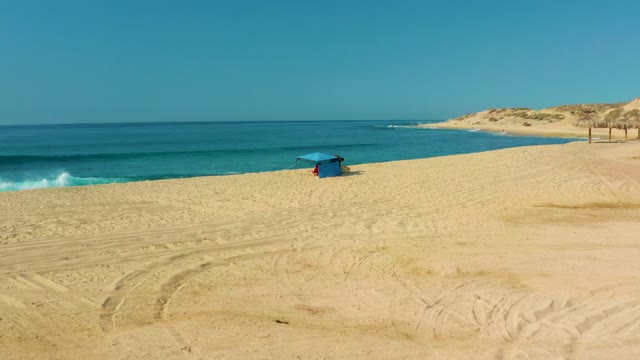SHIPWRECKS LOS CABOS BCS MEXICO-2021: Person Under Blue Hut on Sandy Beach