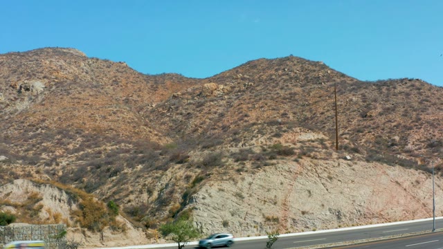 MARQUIS LOS CABOS MEXICO-2021: Vehicles Traveling on a Highway Near Arid Mountains