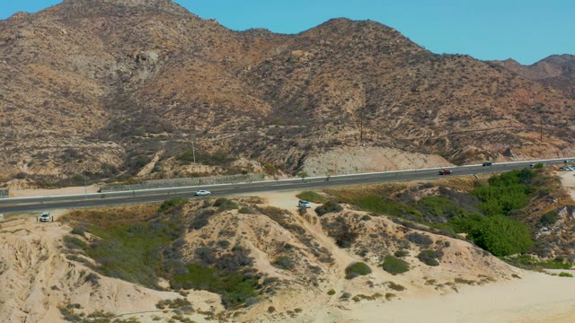 MARQUIS LOS CABOS MEXICO-2021: Highway Traffic Moving Through Desert Mountains