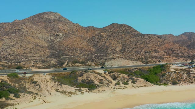 MARQUIS LOS CABOS MEXICO-2021: Coastal Highway with Moving Traffic and Sandy Beach
