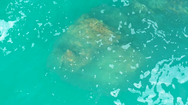 MARQUIS LOS CABOS MEXICO-2021: Rock in Turquoise Water with Moving Surface Foam