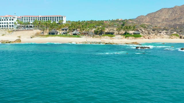 MARQUIS LOS CABOS MEXICO-2021: Waves Breaking on Sandy Beach with Resort