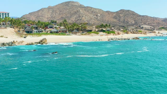 MARQUIS LOS CABOS MEXICO-2021: Coastal Waves Lapping Against Sandy Shore and Rocks