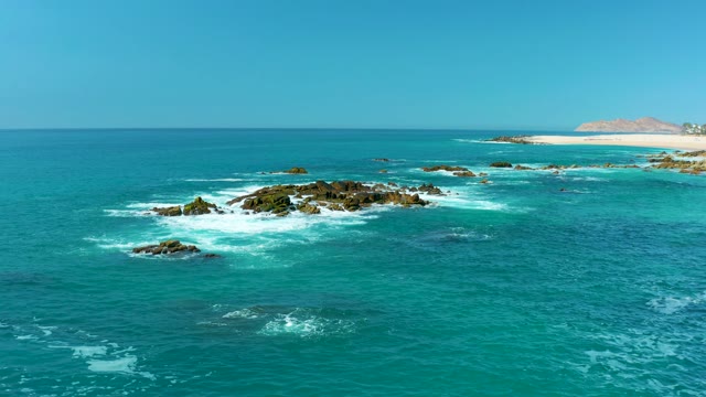 MARQUIS LOS CABOS MEXICO-2021: Ocean Waves Crashing Against Rocky Shoreline